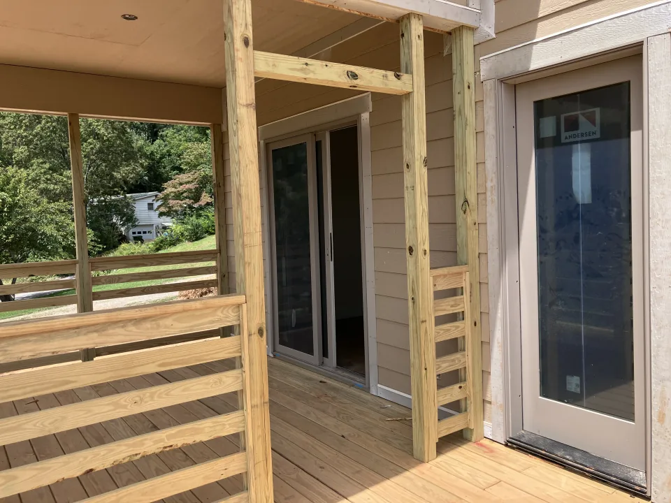 Covered exterior deck with new doors and railings