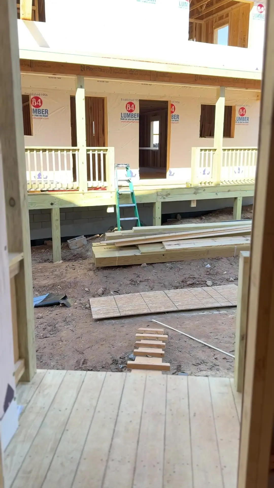 Porches and framing viewed between homes under construction