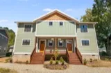 Serviceberry duplex: covered front porches with metal roofs and wood railings at 11 and 13 Fireside Drive