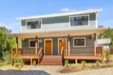 Mulberry duplex: covered front porches with metal roofs and wood railings at 15 and 17 Fireside Drive