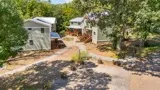Courtyard view of the Firefly Bluff duplexes with gravel pathways and barrel planters