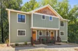 Persimmon duplex: covered front porches with metal roofs and wood railings at 25 and 27 Fireside Drive