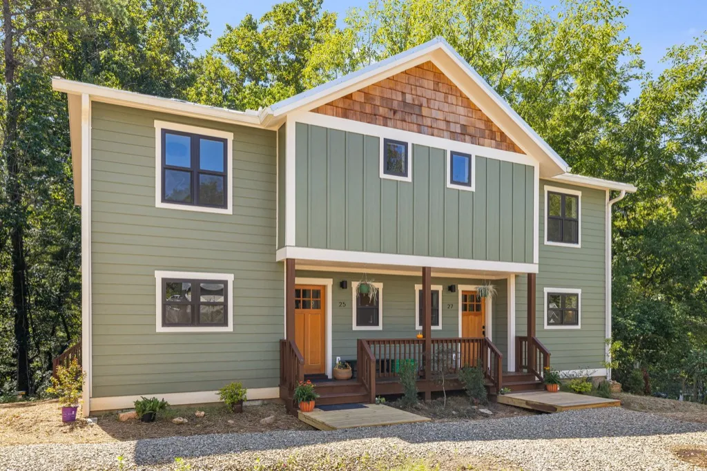 Persimmon duplex: covered front porches with metal roofs and wood railings at 25 and 27 Fireside Drive