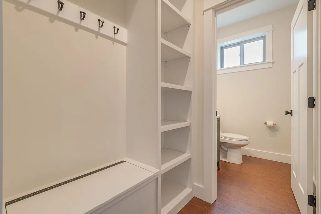 Storage area leading to a half bathroom