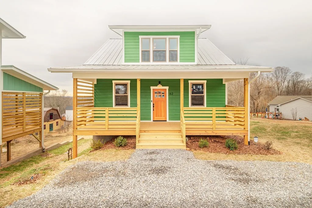 Front exterior of the green home at 62 Huffman Road