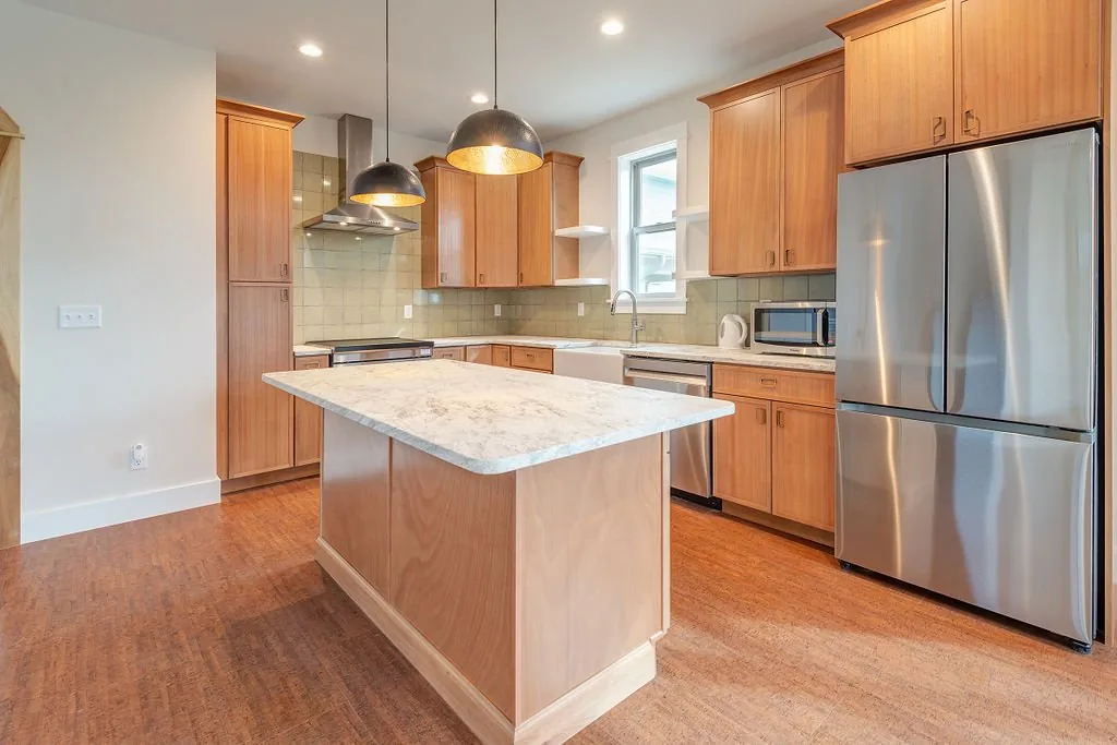 Kitchen with wood cabinets, island, and stainless steel appliances