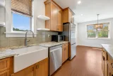 Farmhouse sink under the kitchen window, dining area beyond