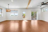 Living area with exposed beam, deck access, and mountain views