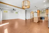 Open main level: kitchen island, arches, and cork floors throughout