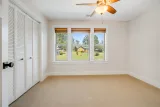 Bedroom with triple window overlooking the front yard