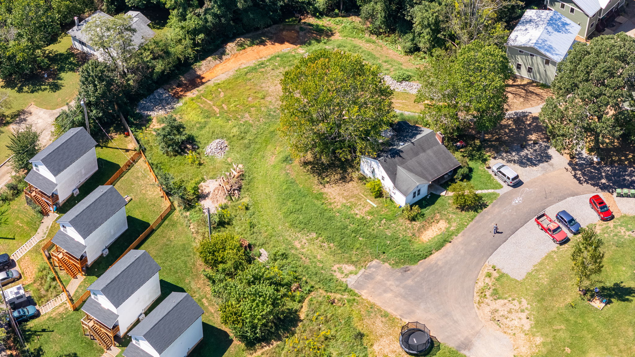 The 1952 farmhouse under its shade tree at the heart of the loop