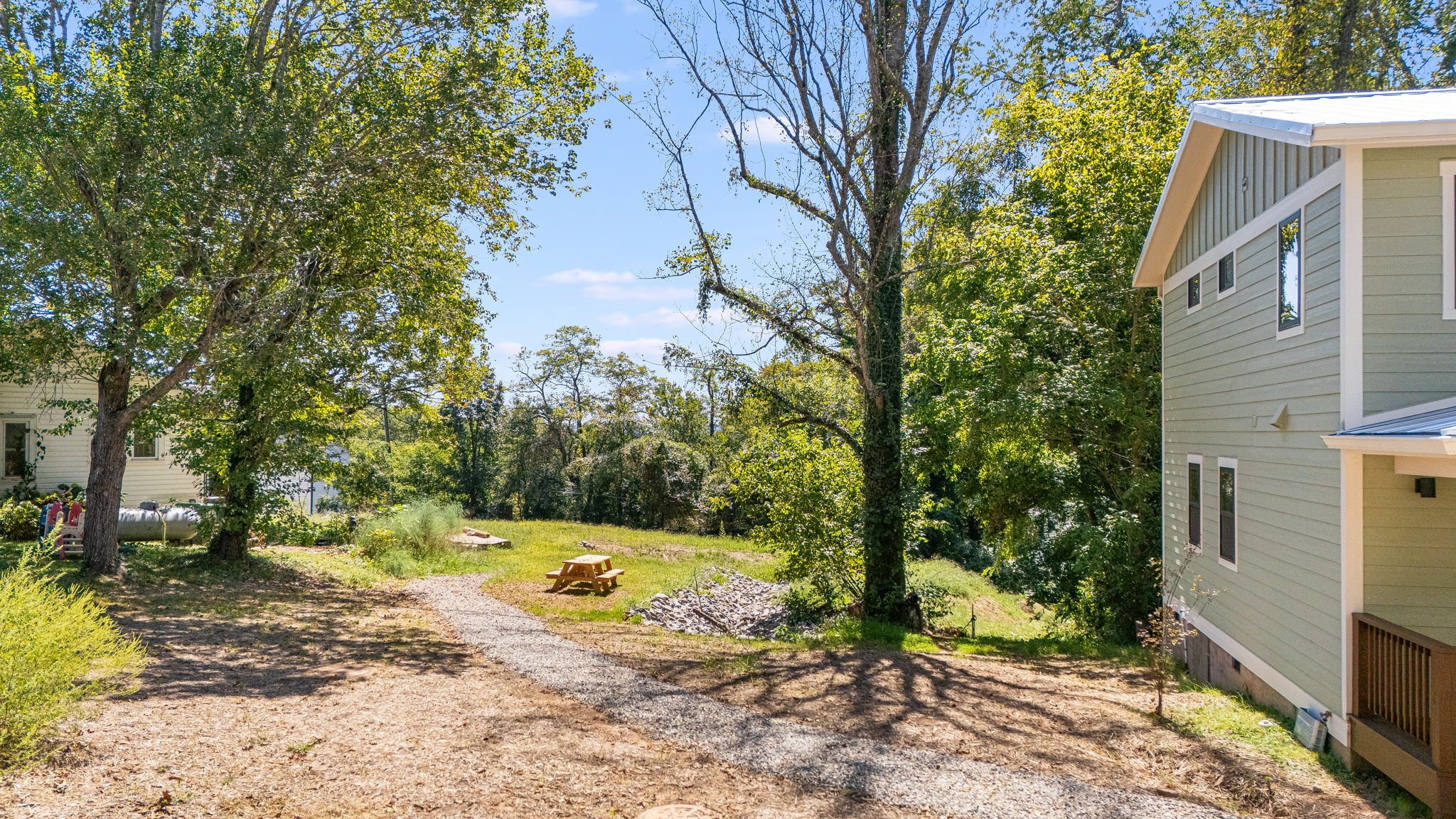 Gravel path to the gathering meadow; farmhouse play yard at left