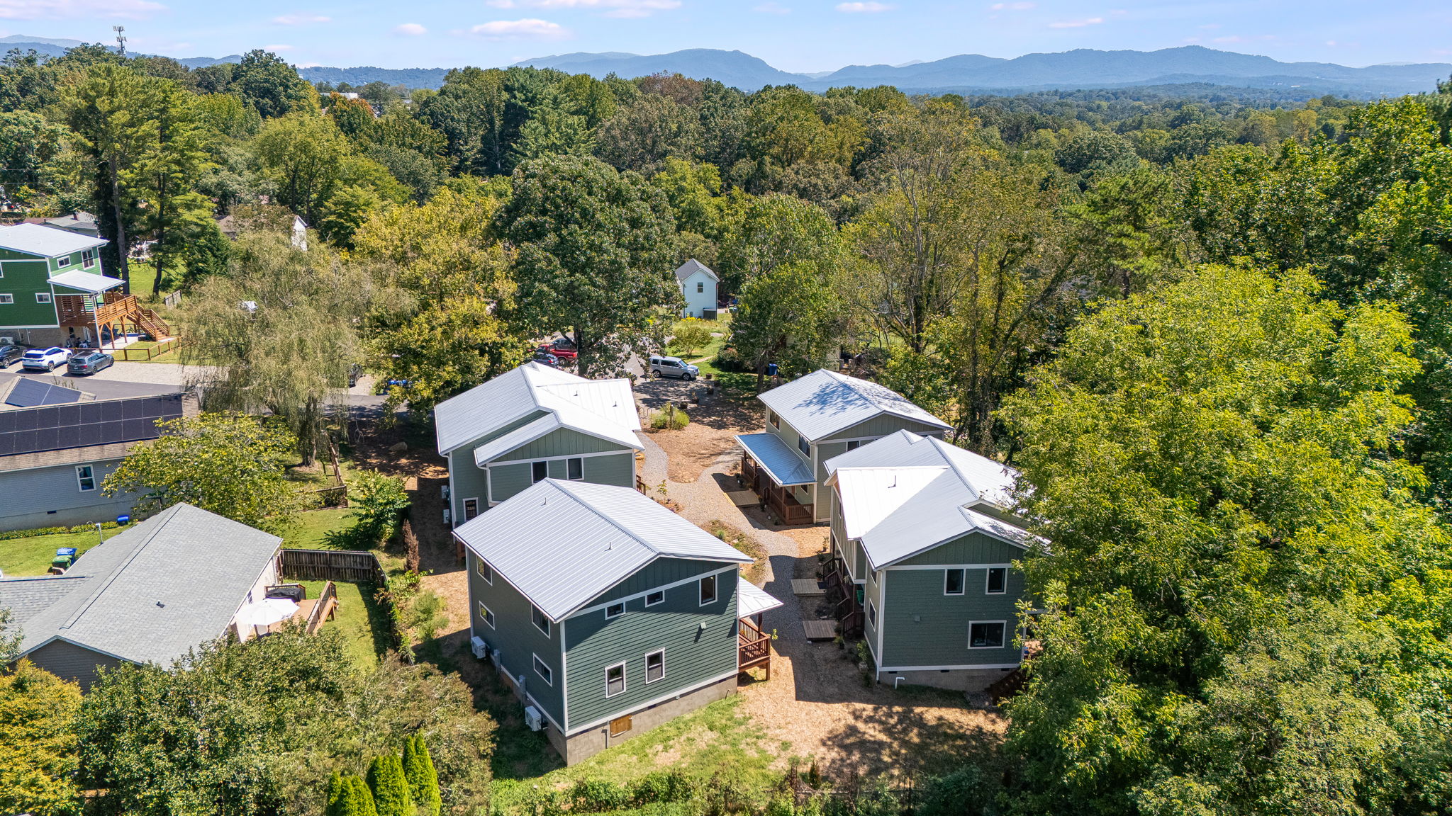 Terra Futura front porches among trees and the Blue Ridge